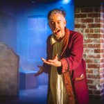 Andrew Price on stage during the show A Christmas Carol