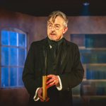 Adrew Price as Scrooge on stage
