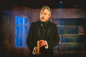 Adrew Price as Scrooge on stage