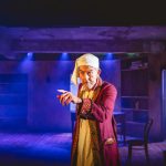 A stage picture of Andrew Price during the show A Christmas Carol
