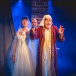 Andrew Price on stage for A Christmas Carol acting as Scrooge